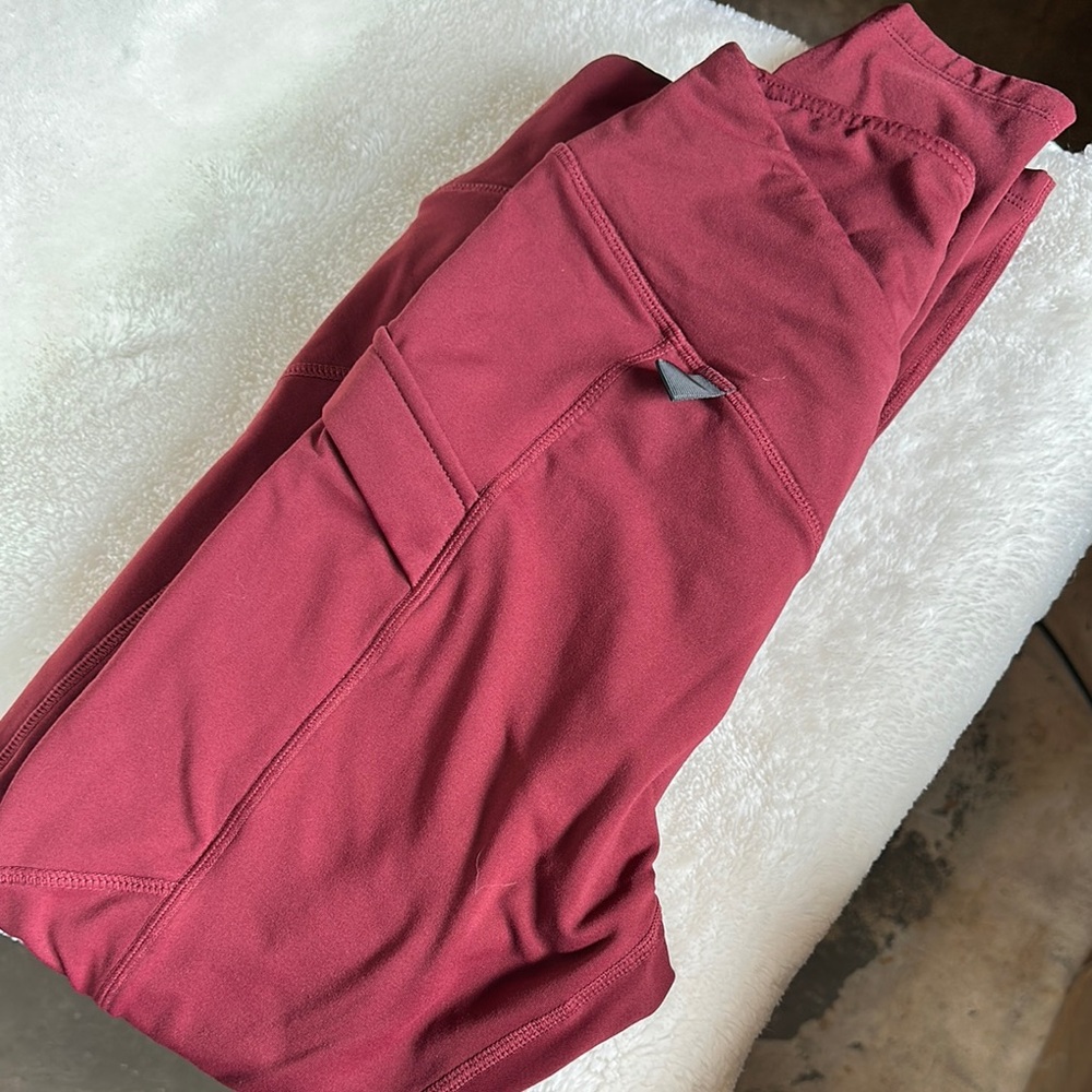 Baleaf dark red size small with inside fleece material that keeps you warm.